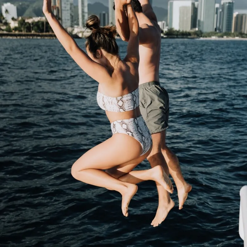 a woman standing next to a body of water