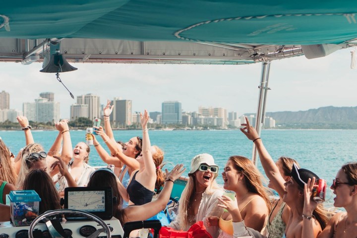 a group of people sitting in front of a body of water