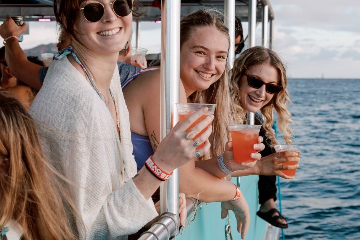 a woman standing on a dock next to a body of water