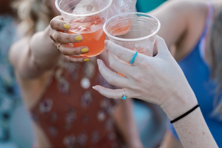 a close up of a person drinking from a cup