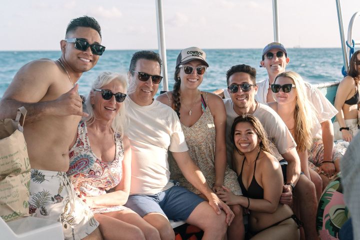 Angie Cano et al. sitting on a boat in the water
