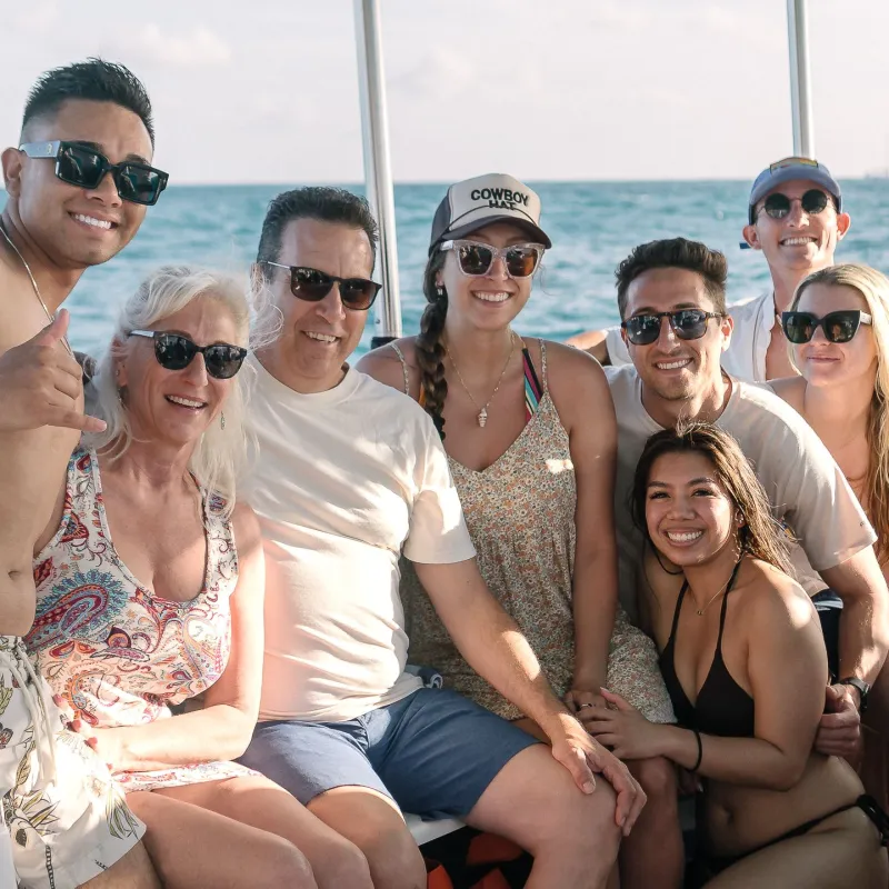 Angie Cano et al. sitting on a boat in the water
