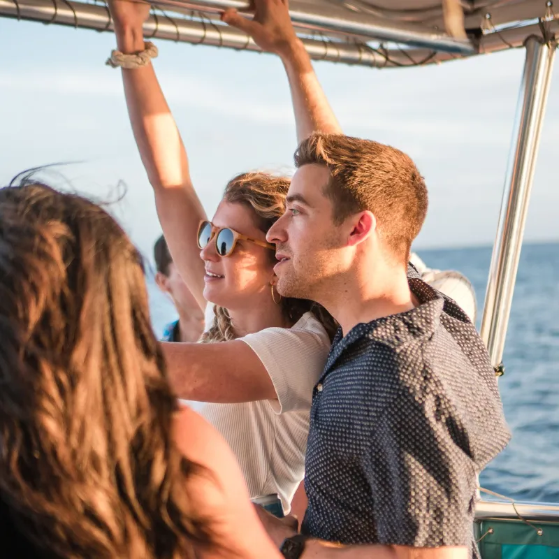 a man standing next to a body of water