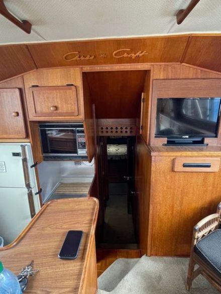 a kitchen with wooden cabinets and a chair