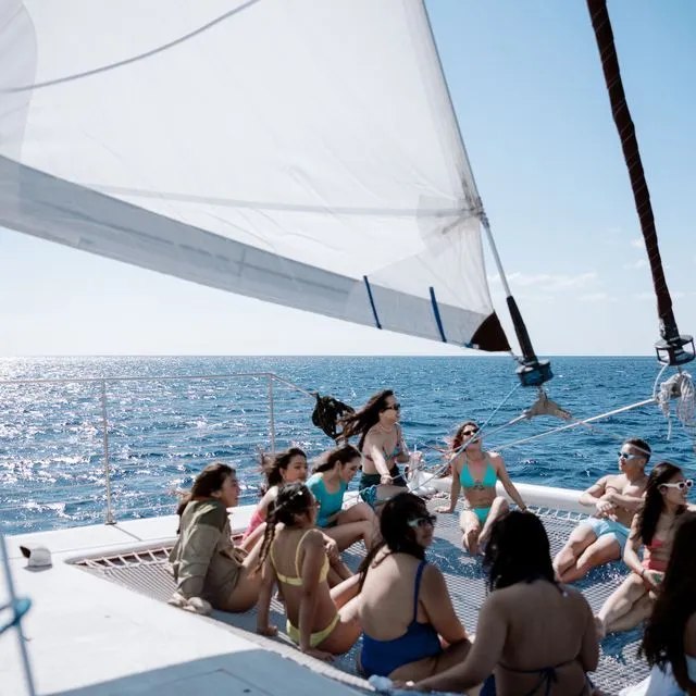 a group of people in a boat on a body of water